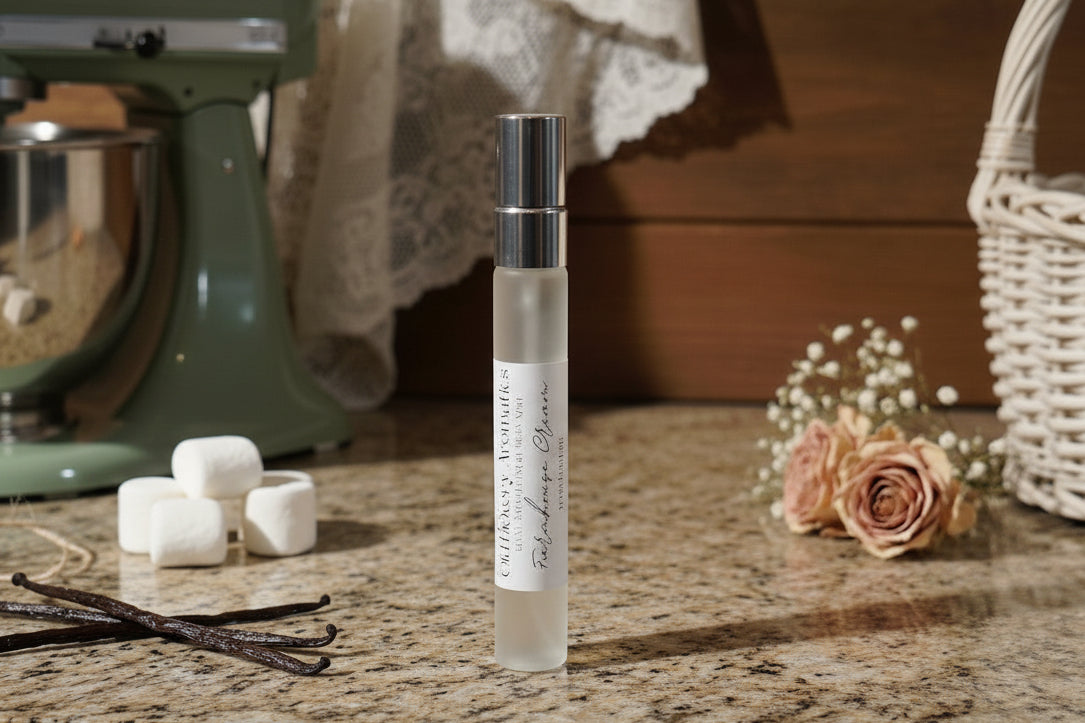 Small bottle of Old Hickory Aromatics body mist on a granite farmhouse kitchen counter with marshmallows, vanilla beans, a stand mixer, flowers, and basket in the background. 