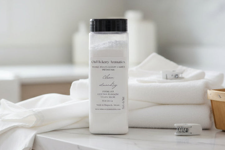 White container of carpet freshener on a laundry room counter with white towels and a window in the background.