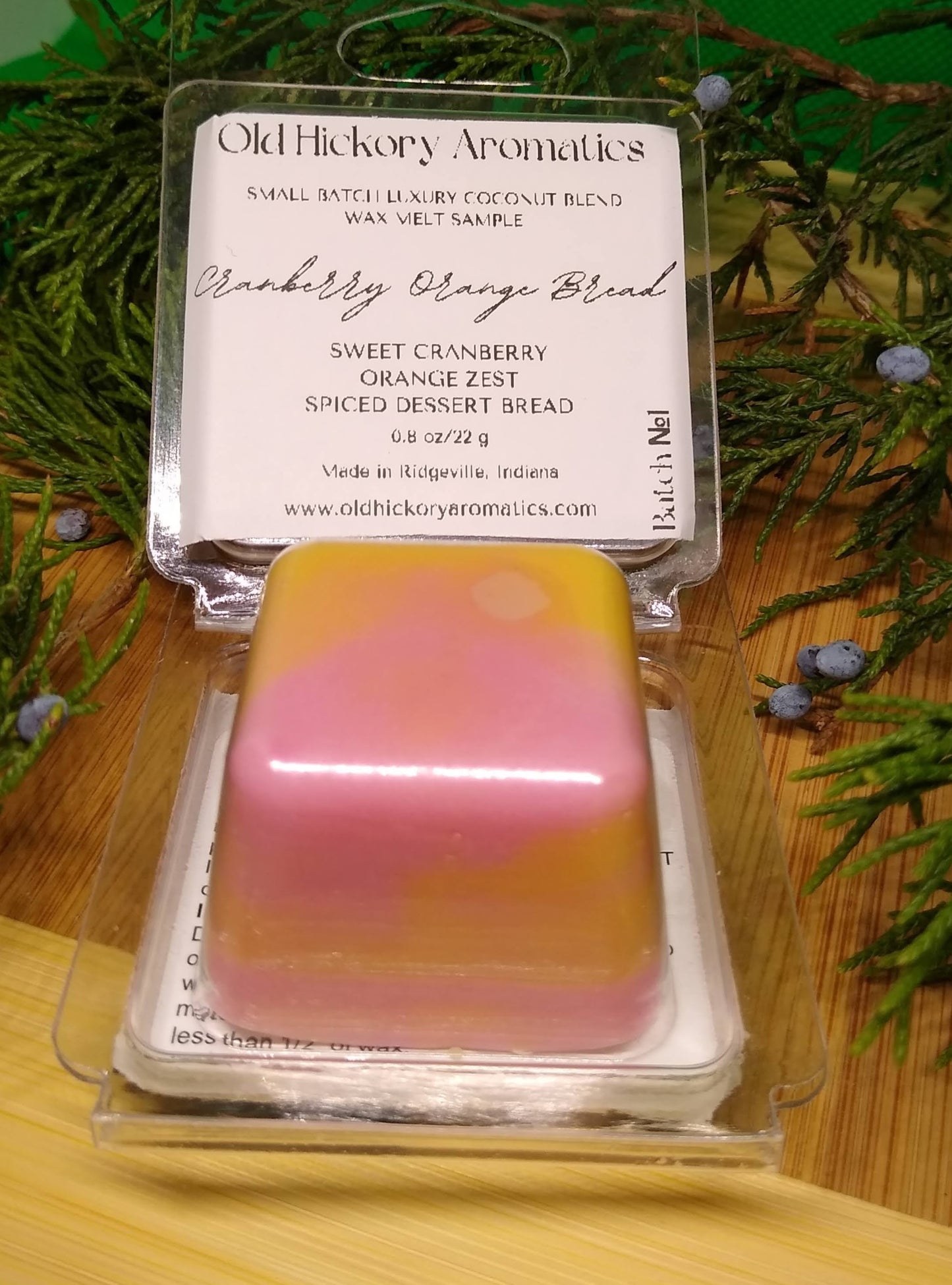 Old Hickory Aromatics Cranberry Orange Bread Wax Melt Sample in packaging on a wooden surface with greenery.